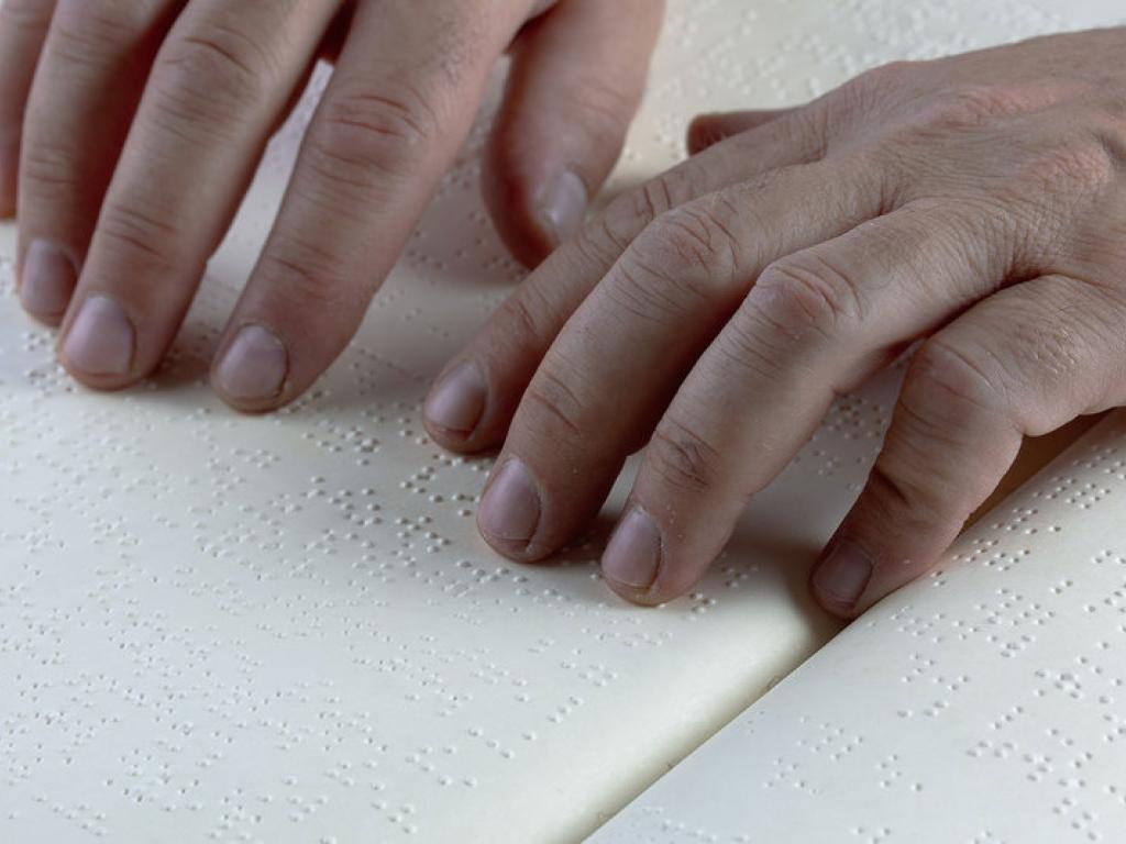 Hands reading braille.